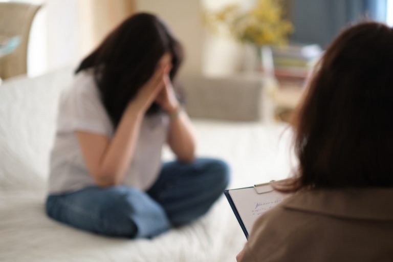 caring psychologist listens empathetically to her patient during a therapy session. She takes